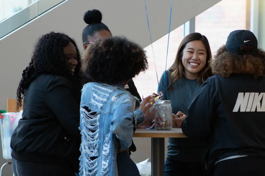 A group of students talking at a table.