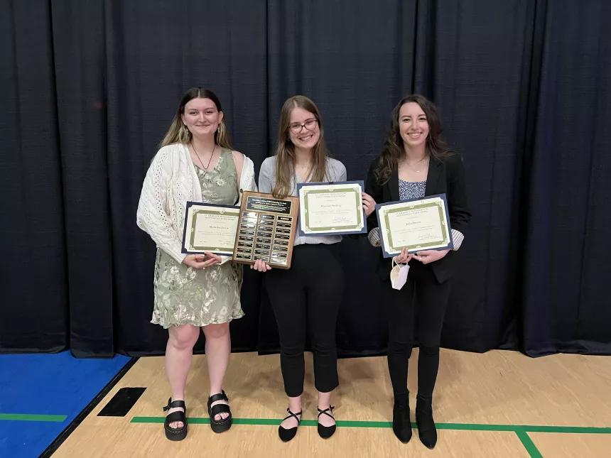 Henderson Outstanding Tutors for 2022 pose inside holding certificates