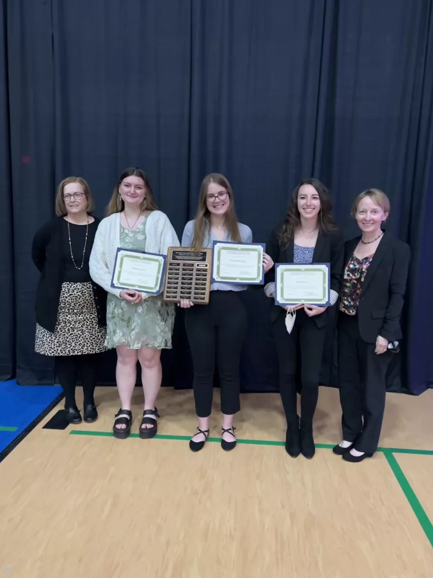 Henderson Outstanding Tutors for 2022 pose inside holding certificates