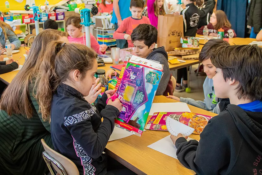 students cut cereal boxes for blades
