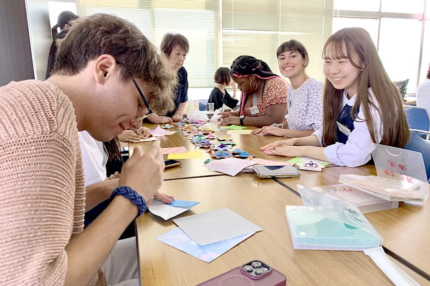 RWU students work alongside others in a classroom in Japan during a study abroad trip.