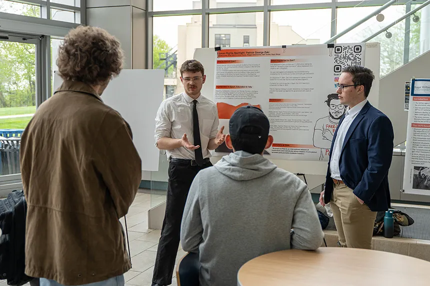 Students talking about their research at SASH. 