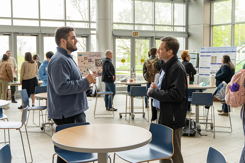 People talking during SASH in the GHH Atrium. 