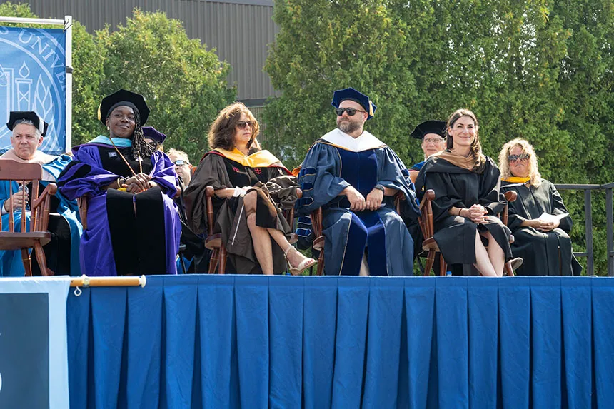 Administrators on the stage during Convocation. 