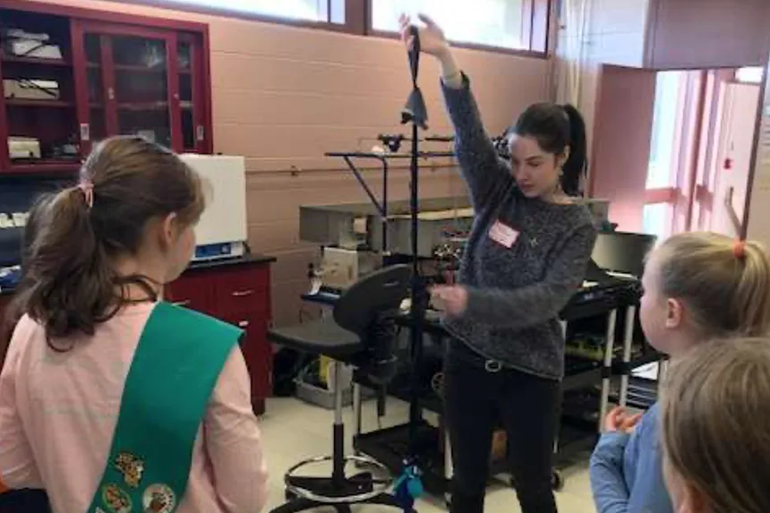 Students demonstrate with girl scouts 