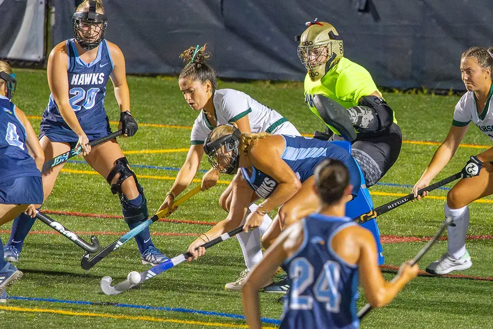 Students compete in a field hockey game