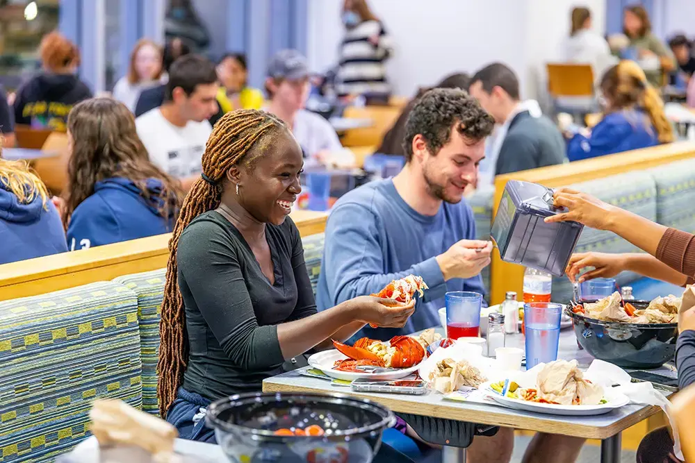 Students eat lobster in the dining hall