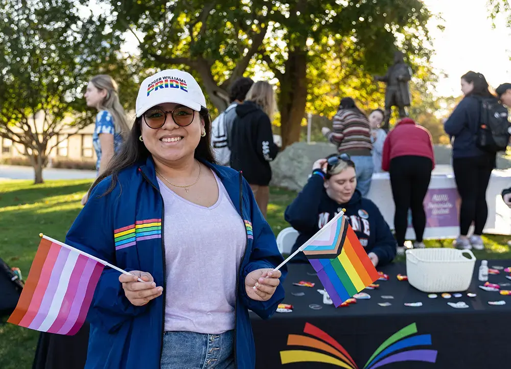 A student holds pride flags