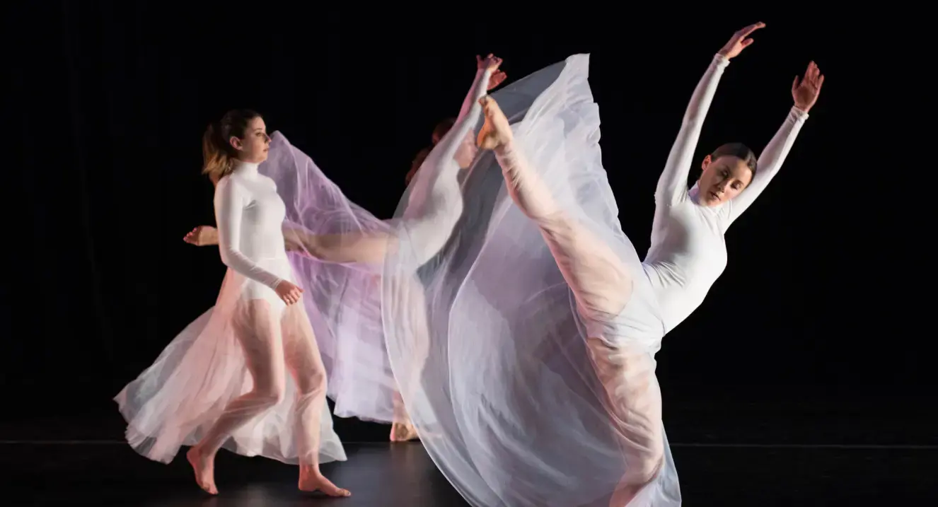 Trio of dancers in white dresses