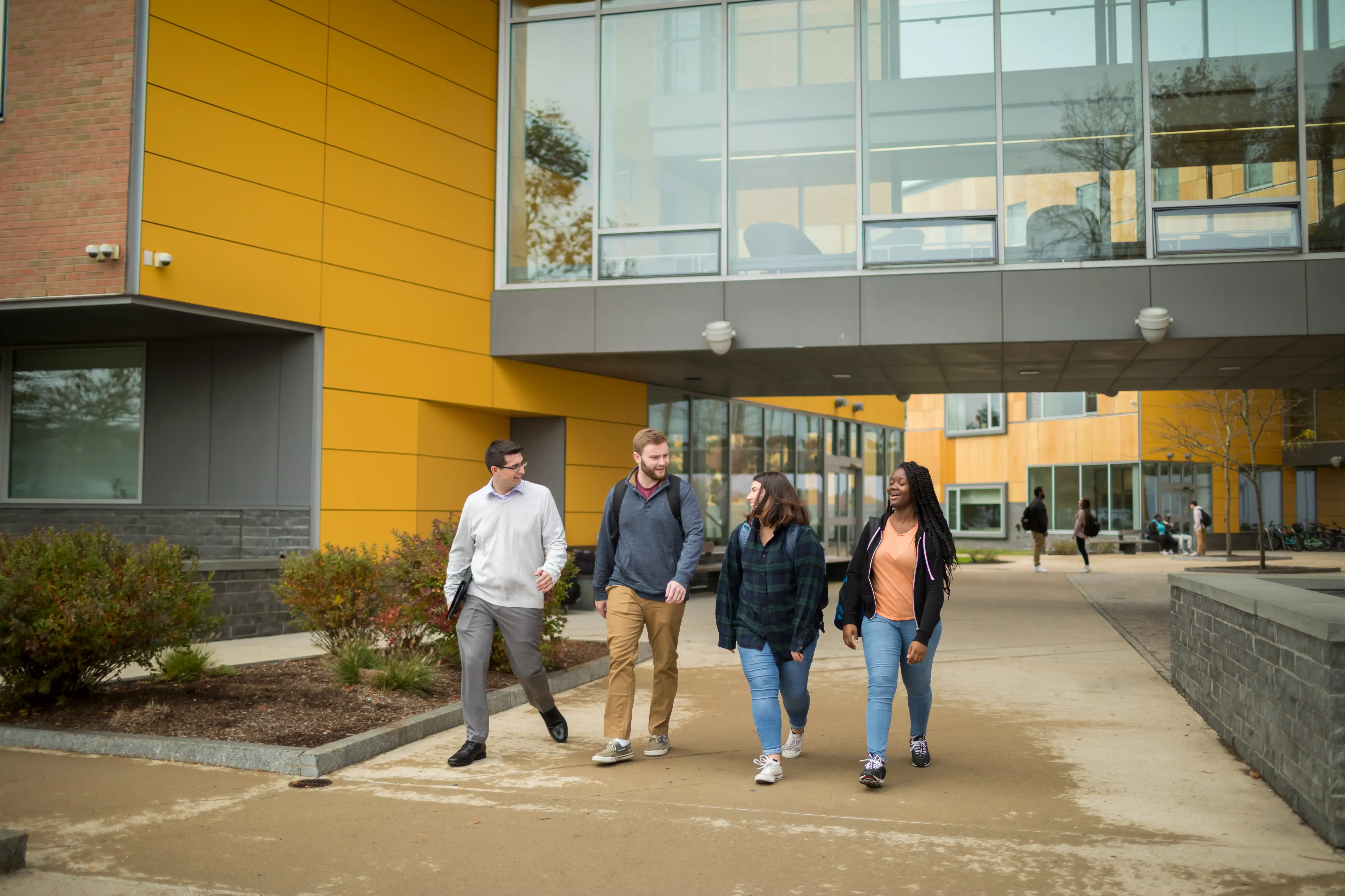 Students walking under building