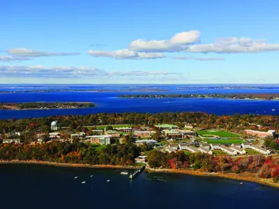 An aerial image of the Roger Williams campus and Mount Hope Bay